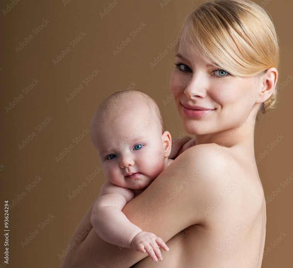 Young mother with a charming baby.Happy family. Mom's love and t Young mother with a charming baby.Happy family. Mom's love and t