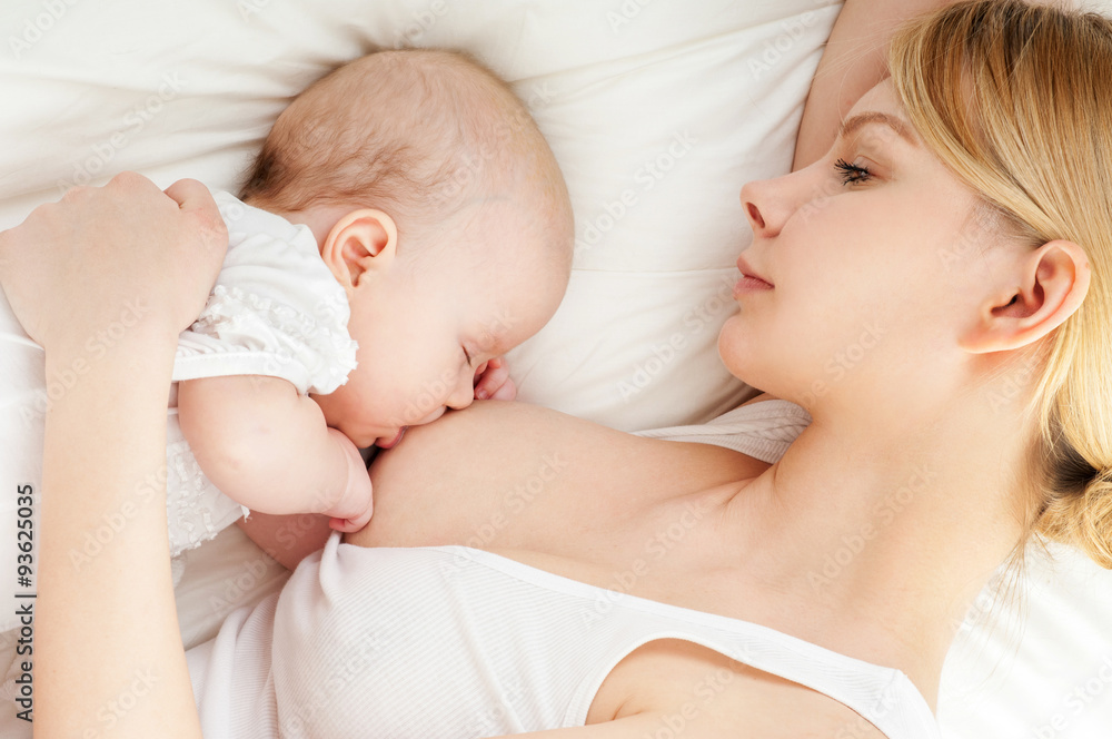 Young mother breastfeeds her baby. Breast-feeding. Young mother breastfeeds her baby. Breast-feeding.