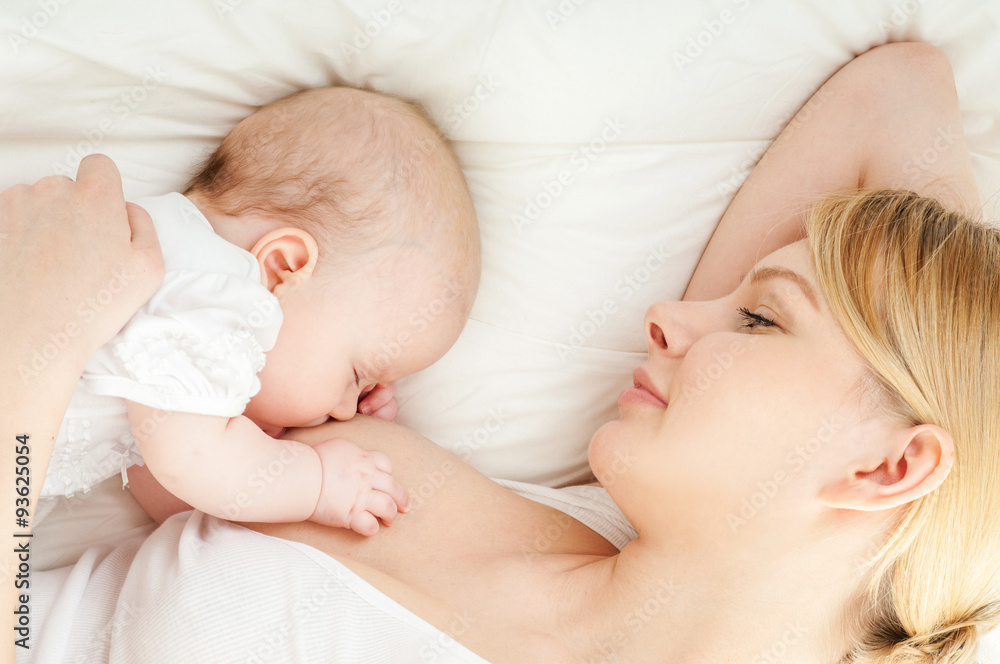 Young mother breastfeeds her baby. Breast-feeding. Young mother breastfeeds her baby. Breast-feeding.