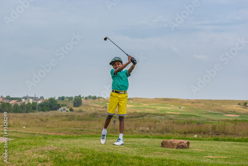 Boy playing golf. South Africa. 