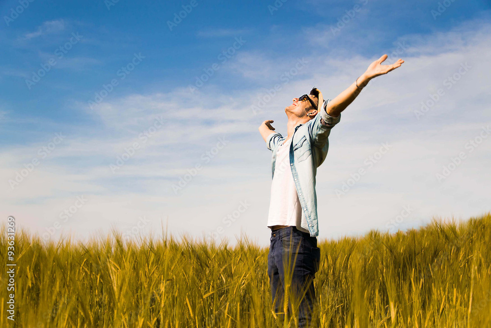 boy feels free putting his hands to the sky,in a countryside-lifestyle,outdoor and emotional concept boy feels free putting his hands to the sky,in a countryside-lifestyle,outdoor and emotional concept