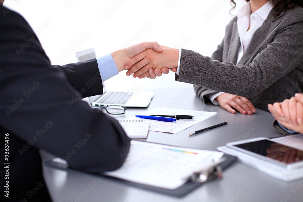 Business people shaking hands, finishing up a meeting Business people shaking hands, finishing up a meeting