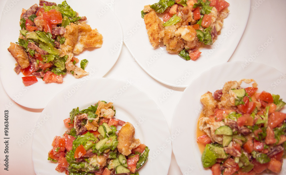 4 plates with salad from cheese, sausages and vegetables 4 plates with salad from cheese, sausages and vegetables