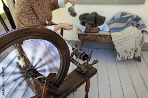 Pioneer historic woman spinning wheel making yarn