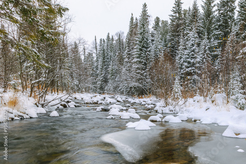 a river in forest with rocks in snow, russian nature