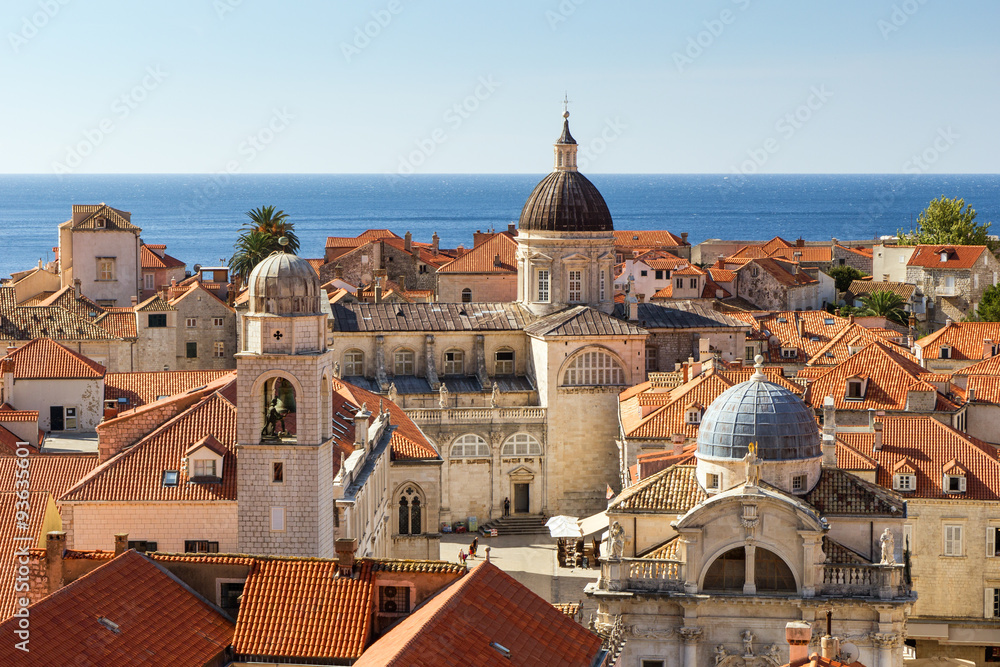Old Town's skyline with red roofs and churches' and cathedrals' towers in Dubrovnik, Croatia, viewed slightly from above.