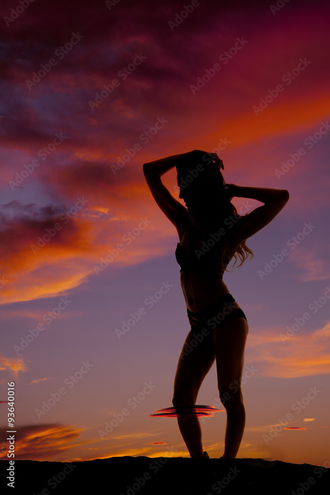 silhouette woman in bikini stand knee out hands up