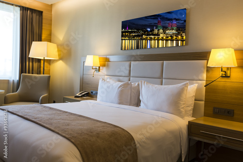 Beautiful hotel room with framed photo on the wall