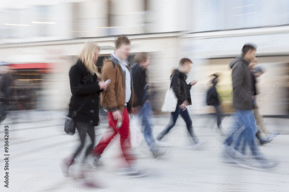 Blurred pedestrian in the city, zoom effect, motion blur