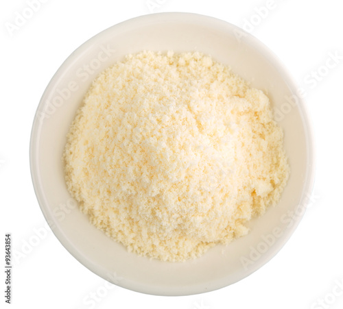 Grated cheese in a white bowl over white background