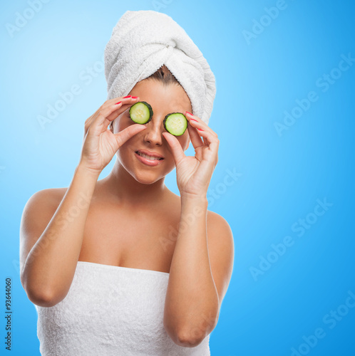 young pretty girl taking a cucumber treatment