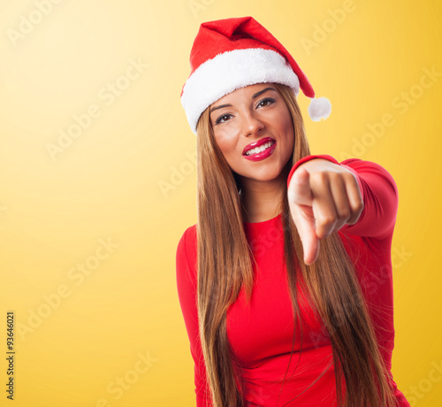 portrait of a beautiful young woman pointing at Christmas