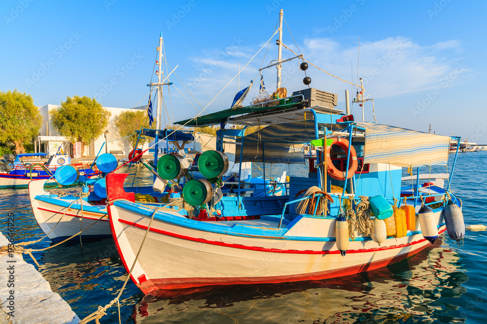 Traditional colourful Greek fishing boat in Pythagorion port at sunset time, Samos island, Greece