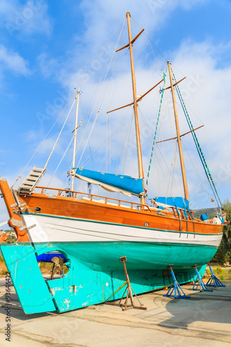 Traditional wooden sail boat in shipyard of small Greek marina, Samos island, Greece