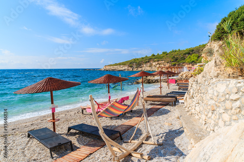 Umbrellas with sunbeds on beautiful beach, Samos island, Greece
