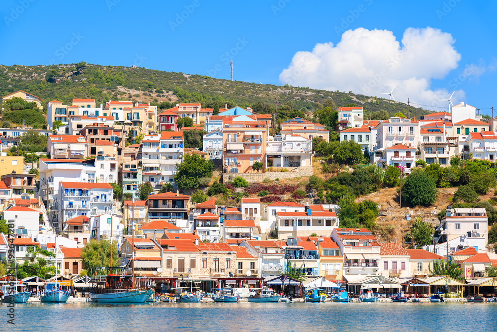 View of Pythagorion port with colourful houses built on hill, Samos island, Greece