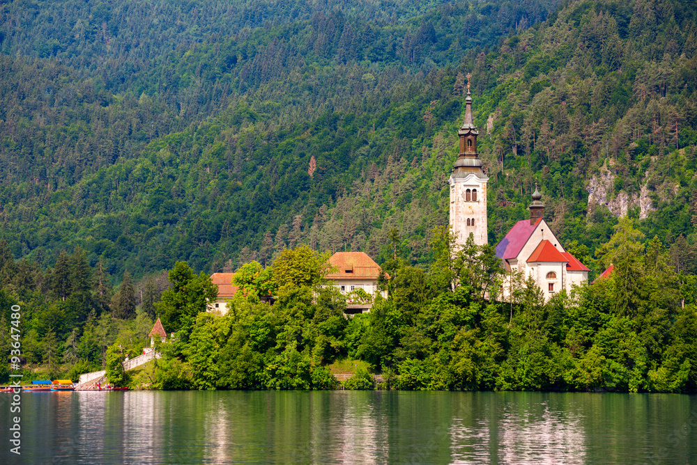Little Island with Catholic Church on Bled Lake, Slovenia and a Hill with Forest in Background