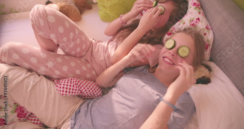 Teen girls in a colourful bedroom smiling and laughing