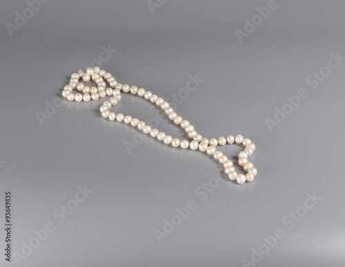 pearl necklace on gray background