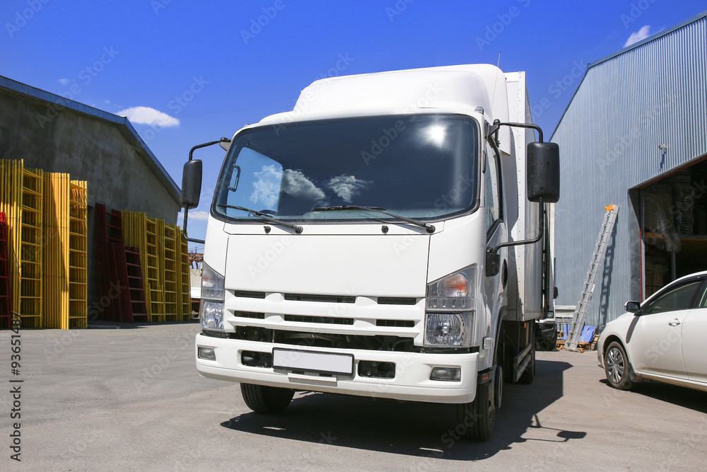 white truck at warehouse buildings white truck at warehouse buildings
