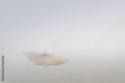 Mysterious small island during misty morning