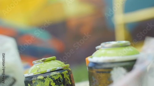 Slow motion of writers hand picking spray can photo