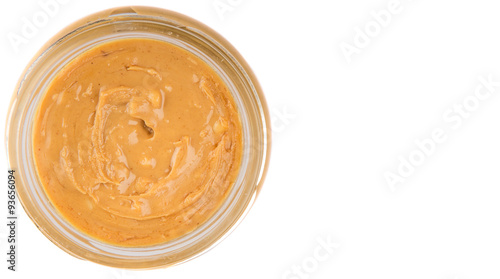 Peanut butter in a mason jar over white background