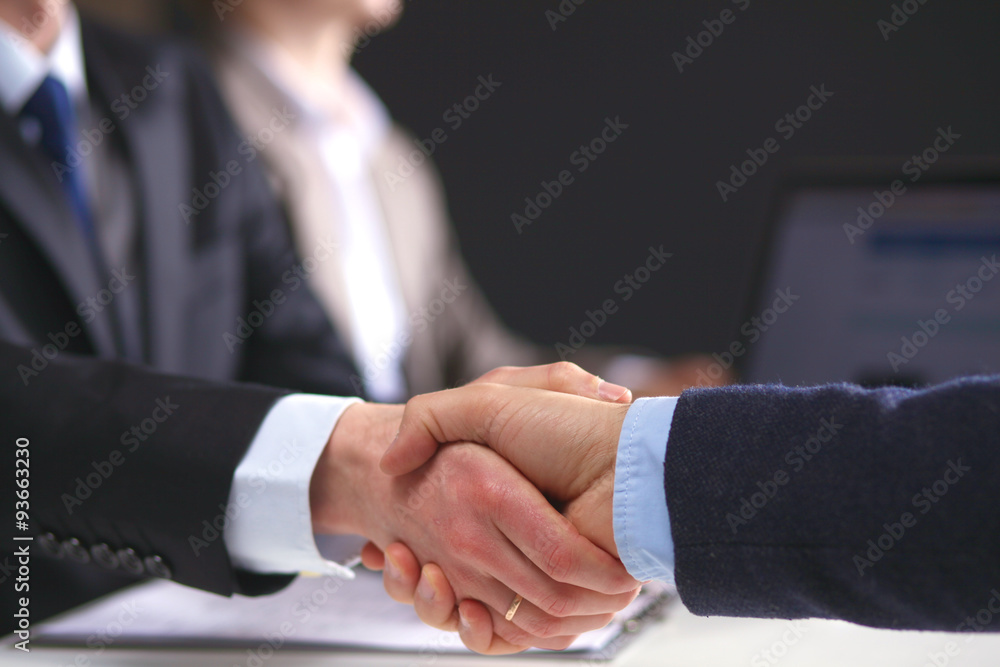 Business meeting at the table shaking hands conclusion of the Business meeting at the table shaking hands conclusion of the