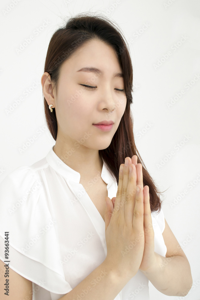 Peaceful asian woman meditating with hands together Peaceful asian woman meditating with hands together