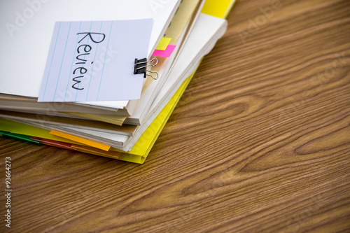 Review  The Pile of Business Documents on the Desk
