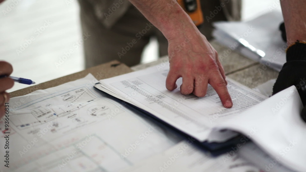 engineer and worker checking a list engineer and worker checking a list