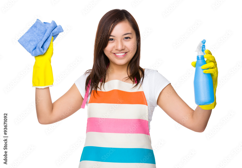Asian housewife using the rag and bottle spray Asian housewife using the rag and bottle spray