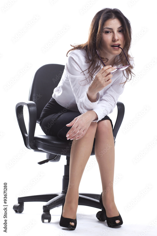 Business woman is sitting and looking us with glasses Business woman is sitting and looking us with glasses