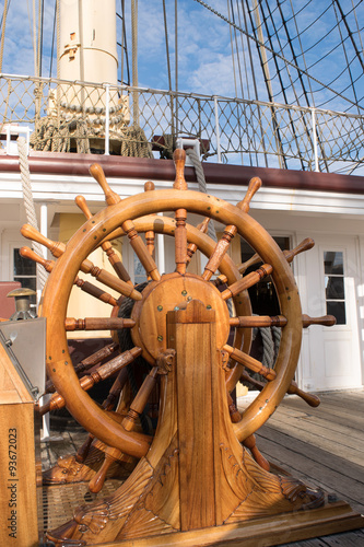 Ships steering wheel on old wooden ship