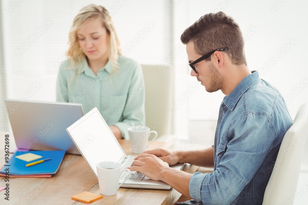 Serious man and woman working on laptop Serious man and woman working on laptop