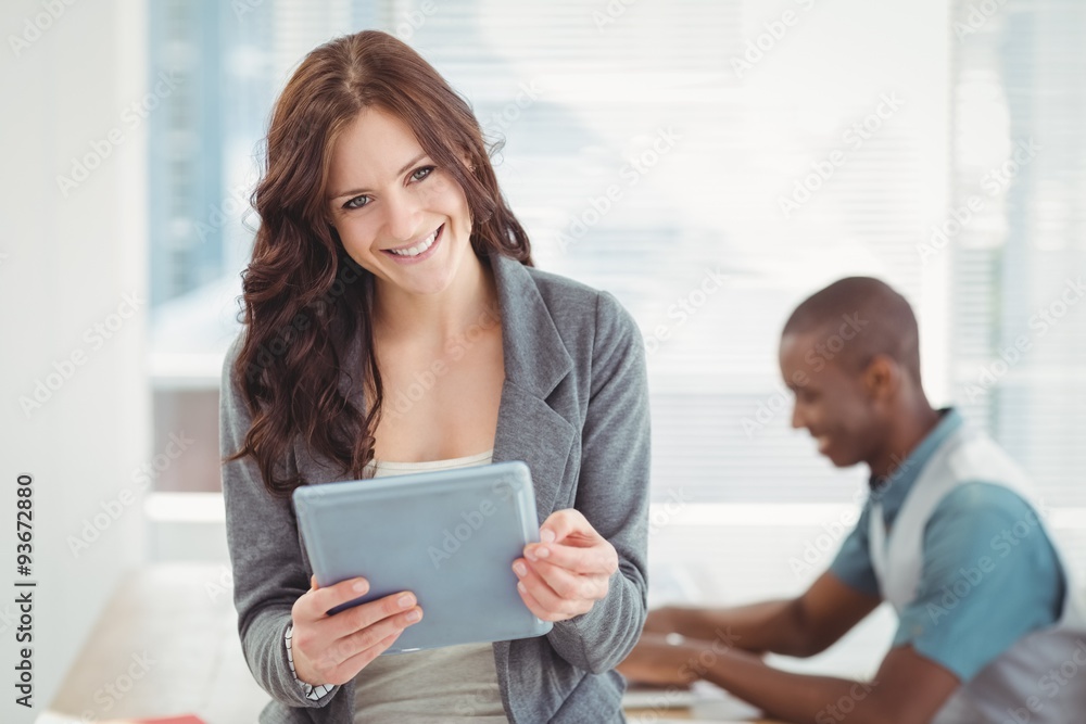 Portrait of smiling woman using digital tablet 
