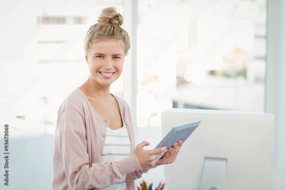 Portrait of smiling woman using digital tablet in office Portrait of smiling woman using digital tablet in office