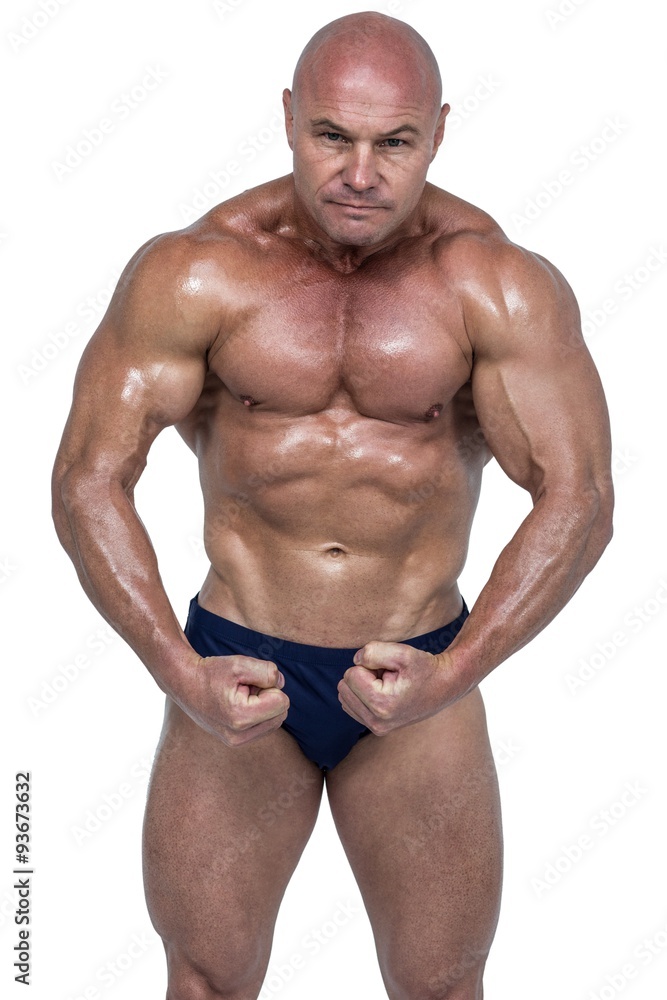 Portrait of shirtless bodybuilder flexing muscles Portrait of shirtless bodybuilder flexing muscles