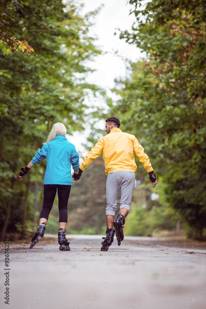 Fototapeta premium Happy couple roller blading together