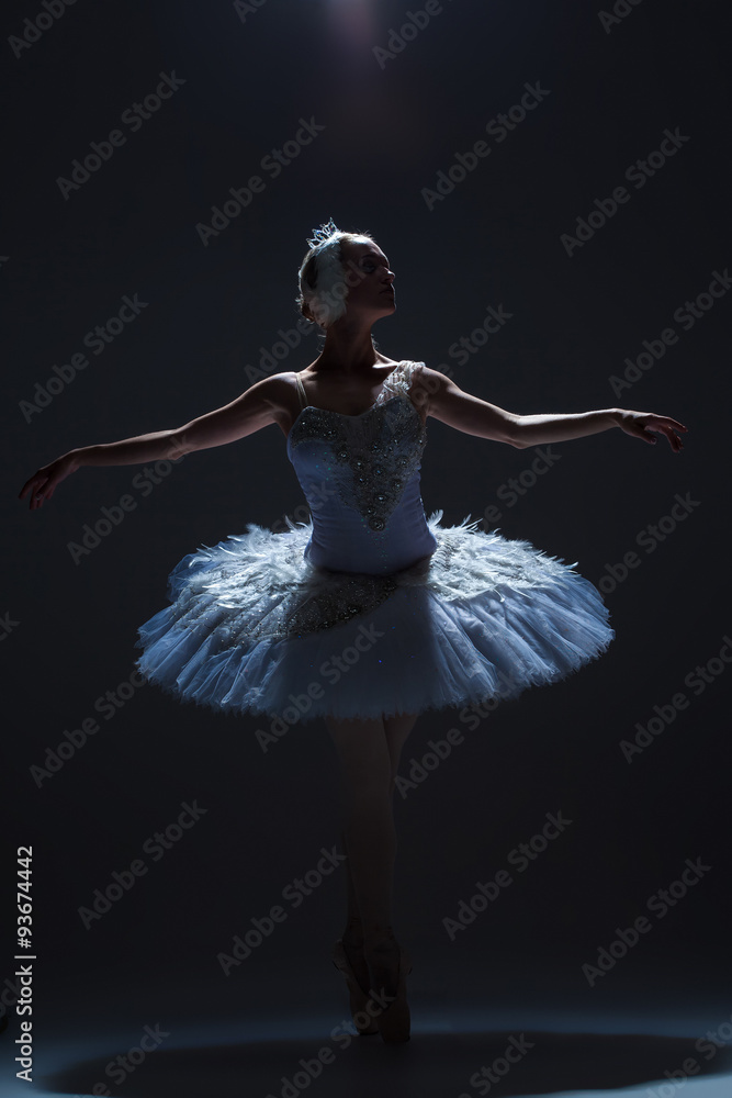 Naklejka premium Portrait of the ballerina in ballet tatu on dack background