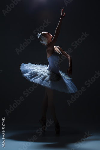 Fototapeta Naklejka Na Ścianę i Meble -  Portrait of the ballerina in ballet tatu on dack background