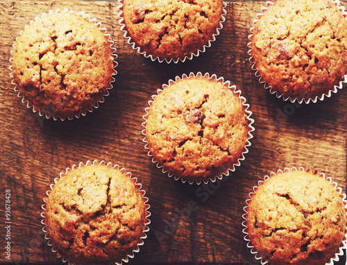 Homemade carrot muffins on brown wooden background