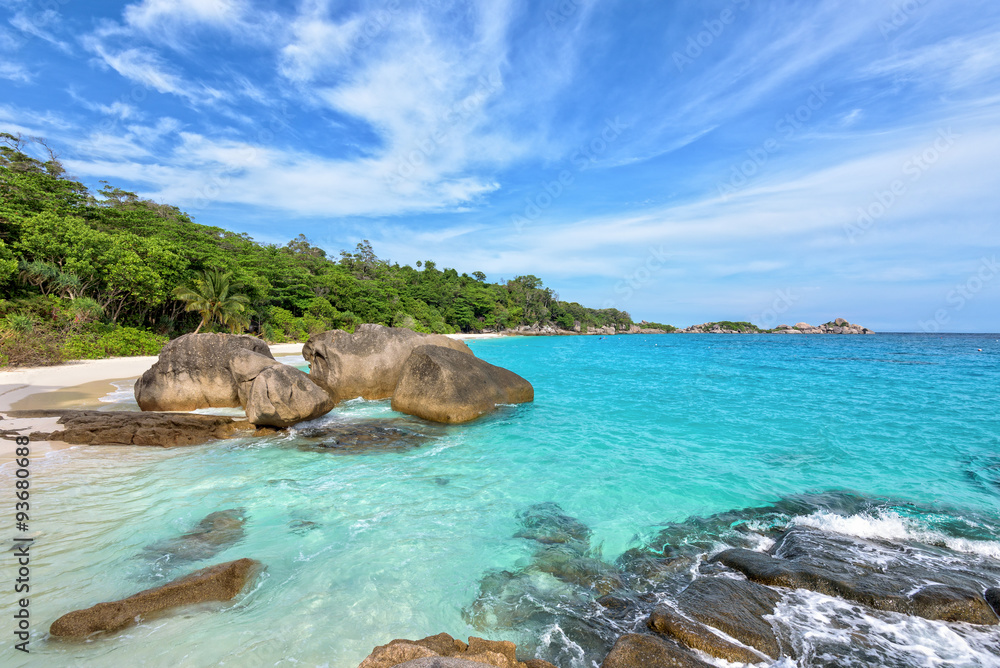 Beautiful landscape of blue sky sea sand and white waves on beach near the rocks during summer at Koh Miang island in Mu Ko Similan National Park, Phang Nga province, Thailand