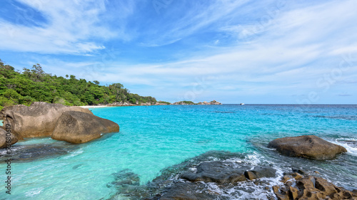 Beautiful landscape blue sky sea and waves on beach near the rocks during summer at Koh Miang island in Mu Ko Similan National Park, Phang Nga province, Thailand, 16:9 widescreen