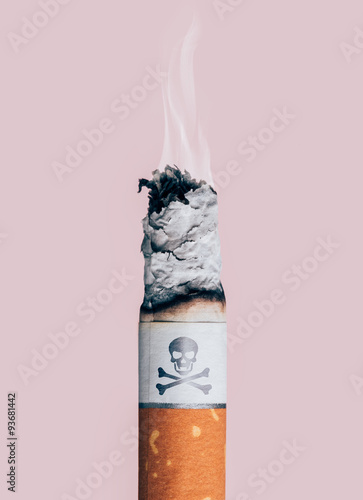 Fotografie Cigarette burning with skull and bones symbol