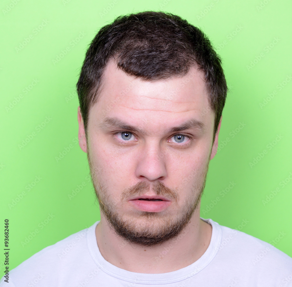 Portrait of man with funny face against green background Portrait of man with funny face against green background