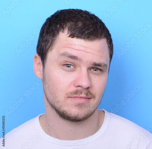 Portrait of handsome man in casual clothes against blue backgrou