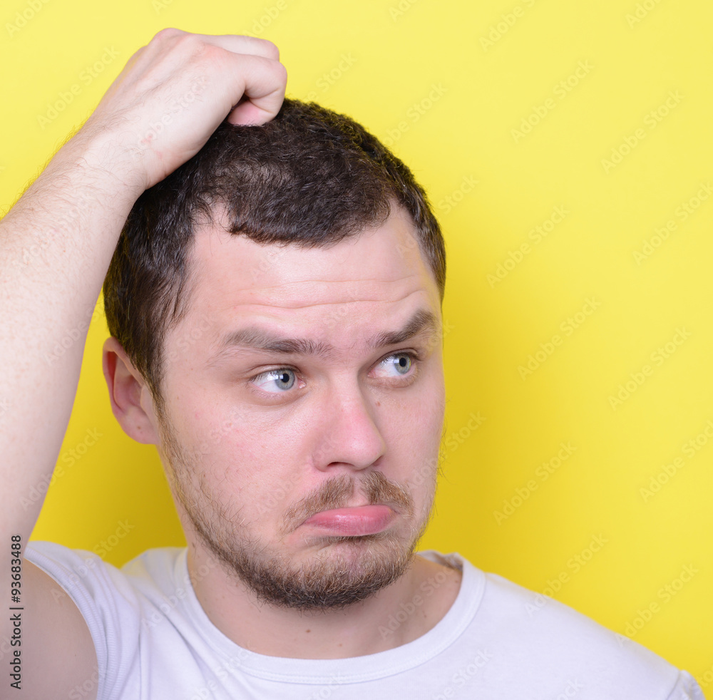 Obraz premium Portrait of funny cluelles man against yellow background