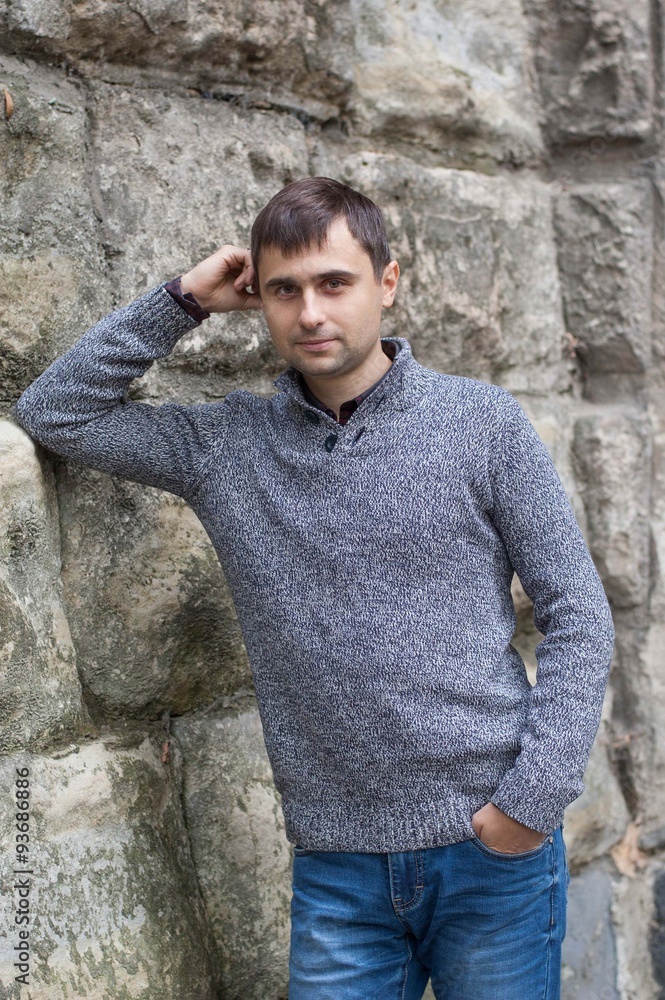 Young man standing near old wall Young man standing near old wall