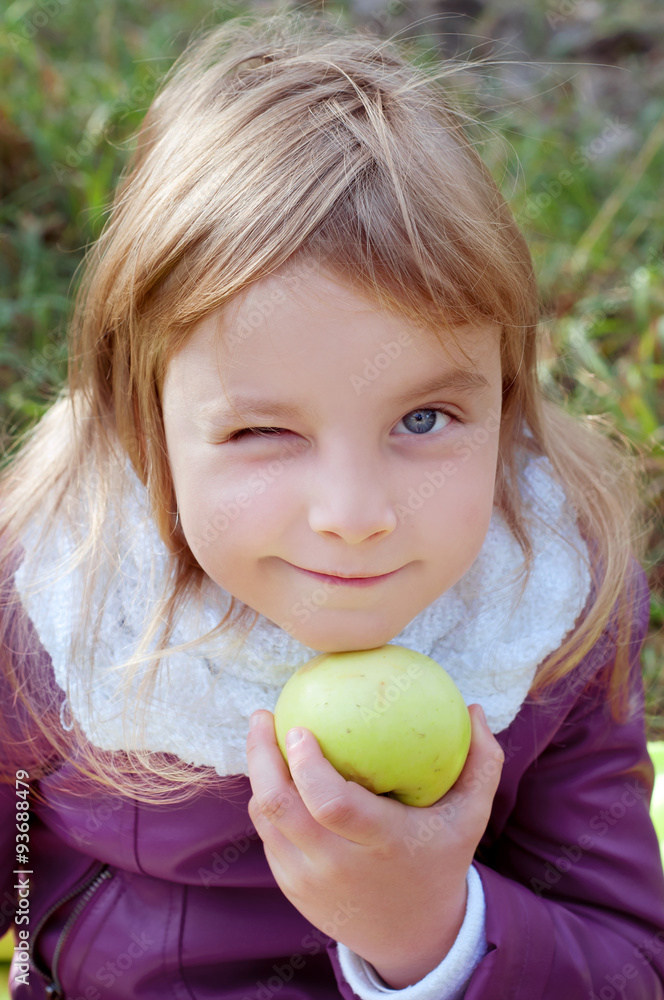 Cute little blond kid holding an apple Cute little blond kid holding an apple
